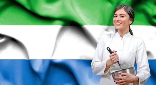 La exigencia del certificado de residencia fiscal puede matizarse cuando se acredite que el Estado en cuestión deniega con carácter general su emisión al interesado. Imagen de una joven chica cocinando frente a la bandera de Sierra Leona