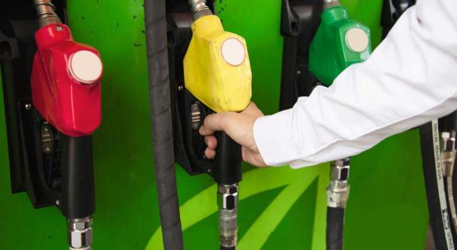 Devolución parcial del Impuesto Especial sobre combustibles derivados del petróleo en Canarias. Imagen de la mano de un hombre cogiendo la manguera amarilla de la gasolina