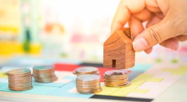 Modificación de las normas de valoración de bienes inmuebles y de determinados derechos. Vivienda en miniatura sobre monedas