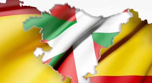 El reparto de la tributación del IVA entre el Estado y el País Vasco que se deriva del concierto, se realiza teniendo en cuenta el origen de los bienes, es decir, el lugar donde se haya generado el valor añadido. Imagen de la bandera de Euskadi sobre la bandera de España