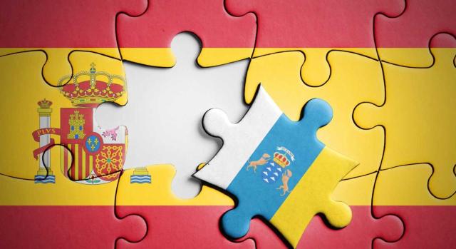TEAC sobre la RIC en Canarias: pérdida del beneficio fiscal por inexistencia de reserva en el patrimonio durante el período de mantenimiento. Imagen del puzzle de la bandera de España y una pieza es la bandera de Canarias